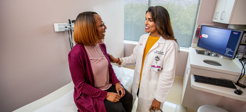 Female caregiver embracing patient.